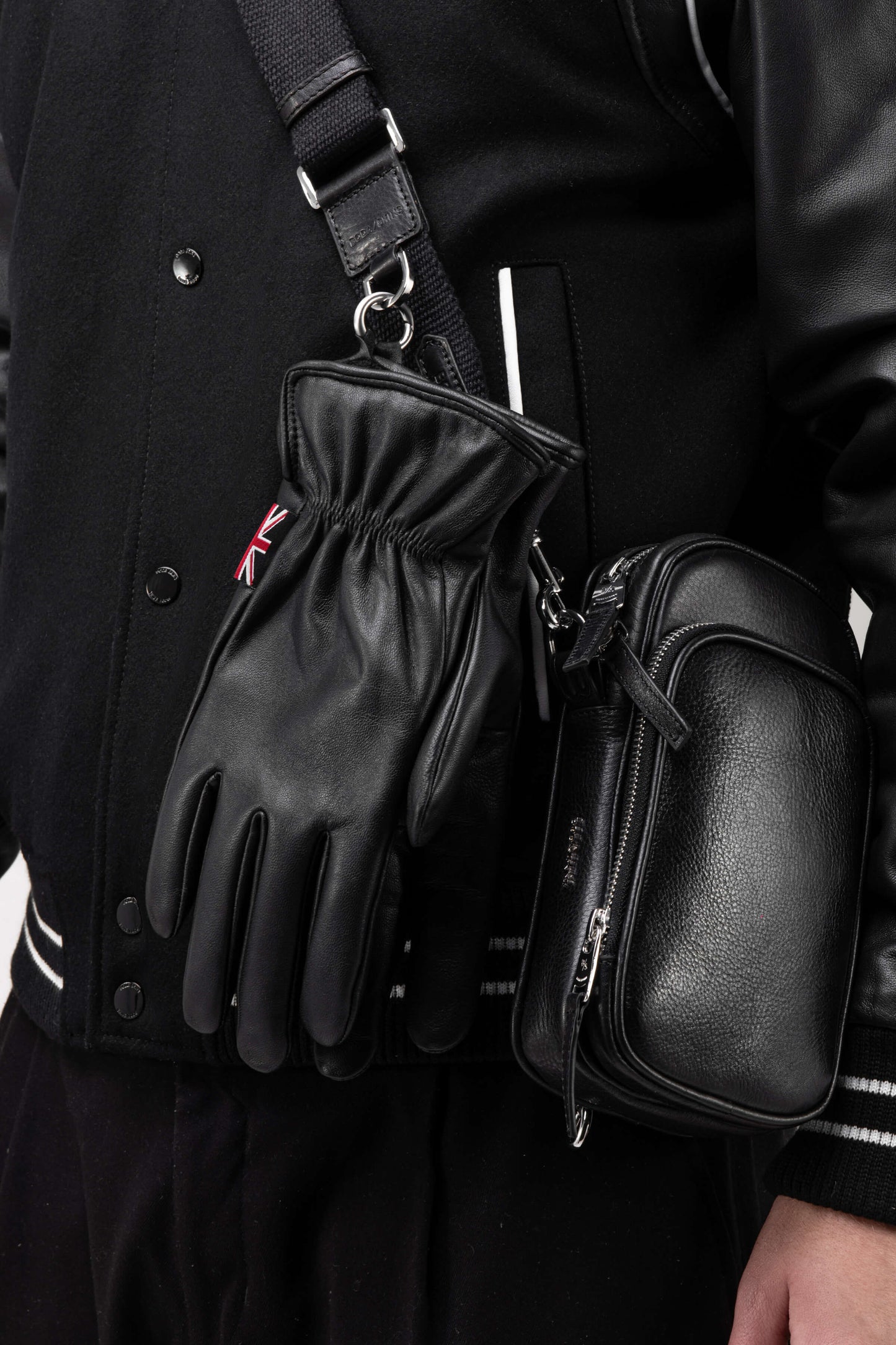 Black leather gloves with small mens bag