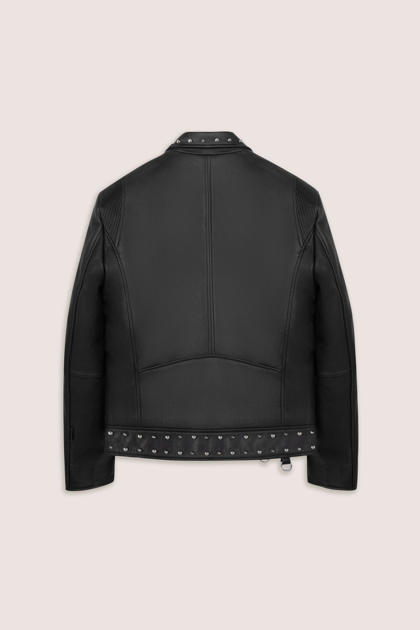 Back of a black leather biker jacket with studded details on a beige background